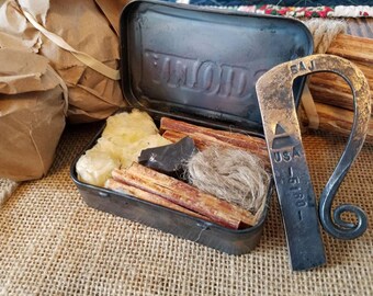 Hand forged flint and steel fire making kit.