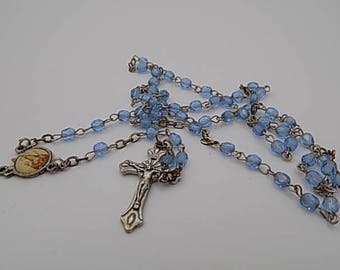 Rosary, religious relic cross statue statue in silver glass beads, on the cross and glass beads