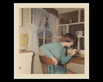 1968 Vintage Kodacolor Print Snapshot Photo: Girl Eating Banana in Kitchen (74570)
