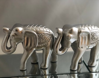 Wooded silver elephant with raised trunk