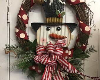 Christmas wreath with metal snowman