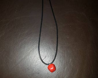 simple necklace with a red bell
