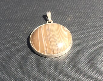 Australian ribbon stone in silver pendant.