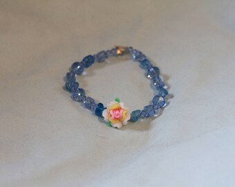 Clear blue bracelet with flower center.