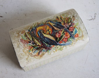 Vintage biscuit tin with two birds and flowers.