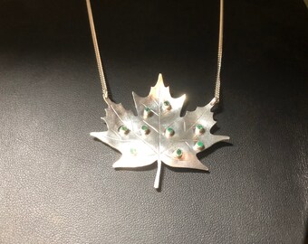 925 sterling silver pendant with natural emeralds.