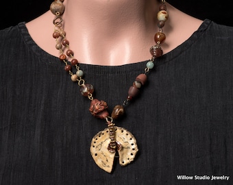 The Message, a rustic assemblage necklace of artisan beads, boho asymmetrical in style, and multicolored