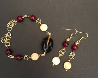 wine and gold bracelet and earrings