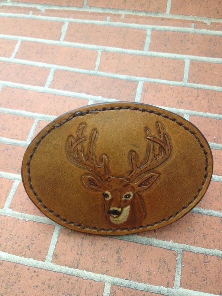 Leather covered buckle with hand tooled deer