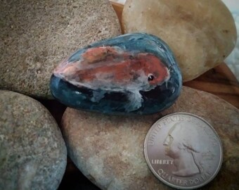 Hand-painted rock featuring a koi detail