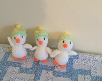 Set of three hand knitted ducks
