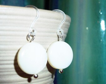 Simple lightweight white mother-of-pearl disc earrings on plastic french hooks for sensitive ears