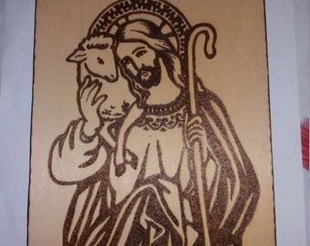 Burning painting by hand. Jesus and Lamb