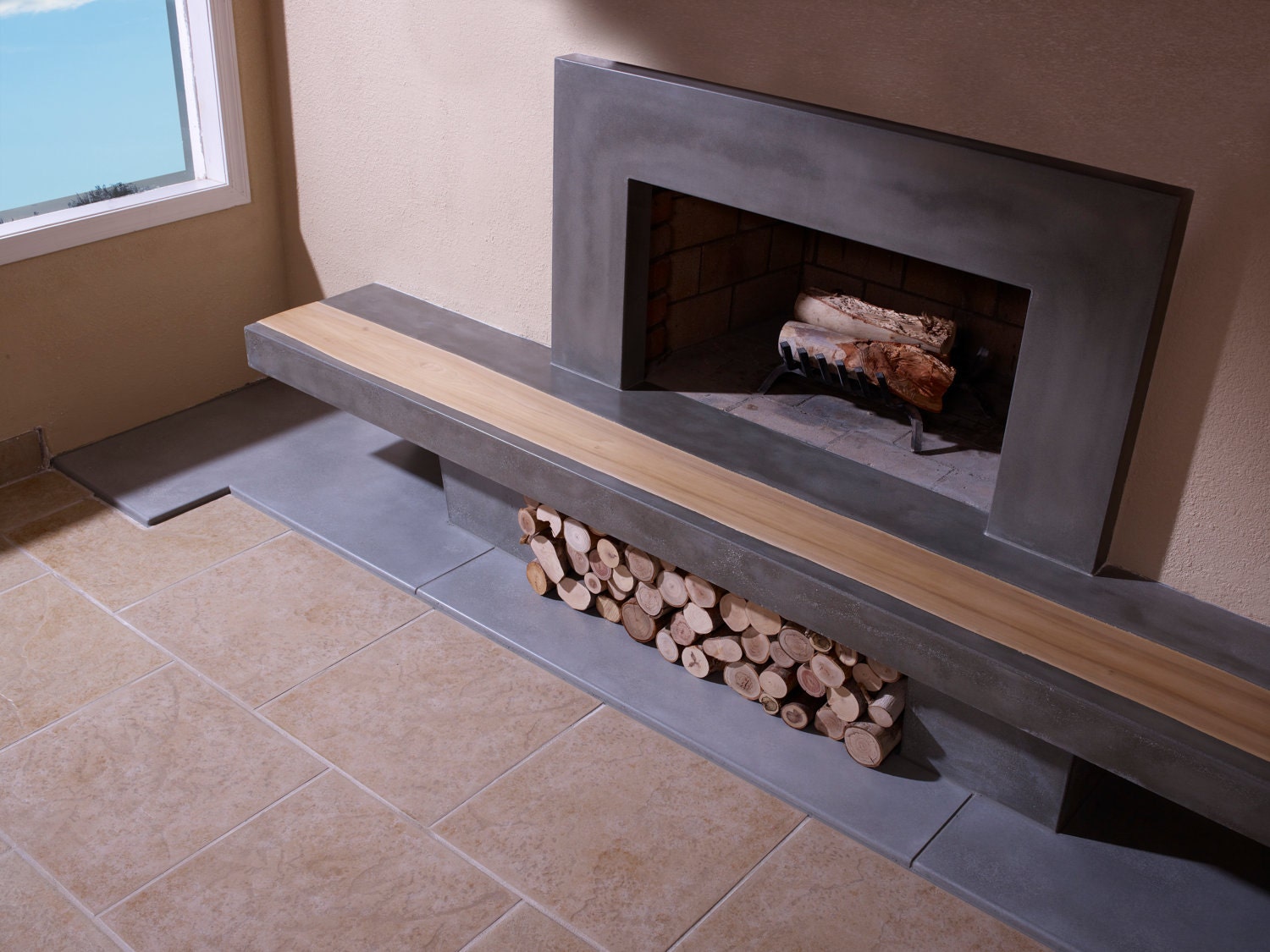 Concrete Fireplace Hearth with Wood Inlay and Surround This is a custom concrete fireplace hearth with poplar wood inlay and surround made for a local client in the Phoenix area. The hearth is 108 long