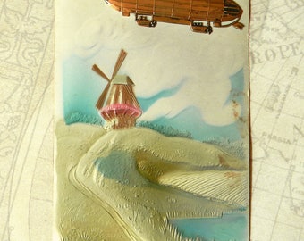 100+ Year Old Airship Dirigible Postcard. Beautiully Embossed w/Mounted Metal Stamping Airship Insignia. Made in Germany. Postmarked 1908.
