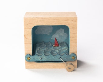 Kinetic Sailboat Sculpture, with Blue Sky and Clouds