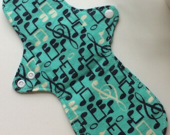 11 inch Large reusable pad, teal Music note pattern, light flow, cam snaps