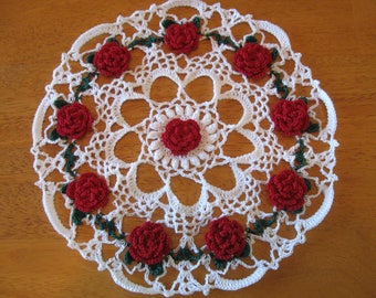 New white hand-crocheted doily with red roses
