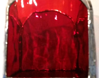 Red/orange stained glass tea light candle holder.