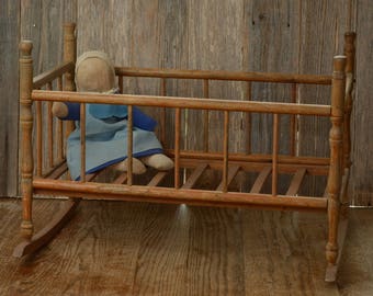 ROCKING DOLL BED-An Old Wood Doll Bed, with the mattress slat frame and turned corner pieces.