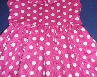 Polka dotted dress with ruffle at the neck.