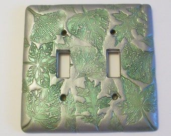 Double toggle light switch cover Collage of leaves in silver and metallic green