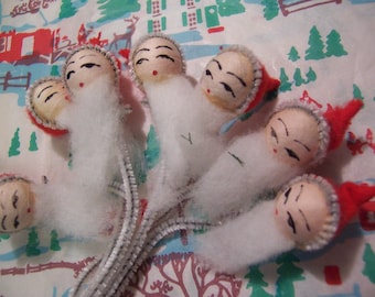seven little styrofoam santa heads