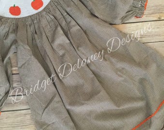 Brown gingham dress, smocked pumpkins, scallop hem.