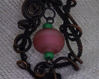 Rosengarten...patinierter copper wire with a sand-washed bead