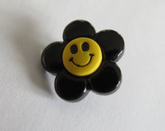 Yellow and black flower shaped button