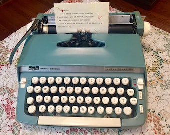 A 1960's Smith Corona Super Sterling Portable Manual Blue Typewriter
