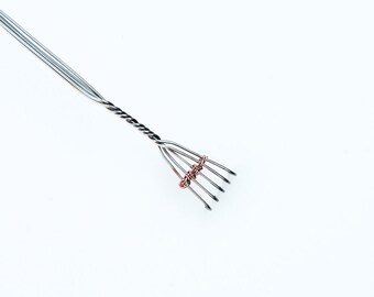 Fingers, a stainless steel back scratcher with serial number and lifetime warranty