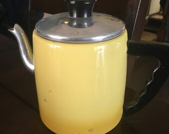 Yellow enamelware tea pot