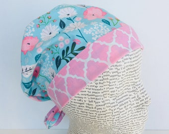 Tie Back Scrub Cap scrub hat featuring a light blue material with flowers in pink and white with a coordinating band 2t