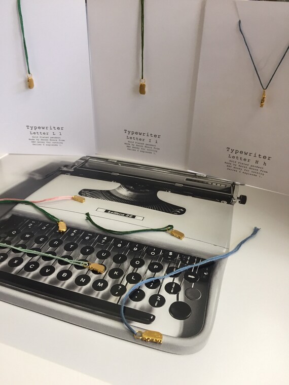 Gold plated typewritter key pendents made by Sarah Moore from BBC tv series Money For Nothing