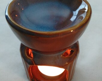 Elegance Fragrance Warmers with three small candles and one bottle of fragrance oil.