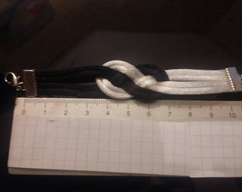 A black and white sailor knot bracelet.