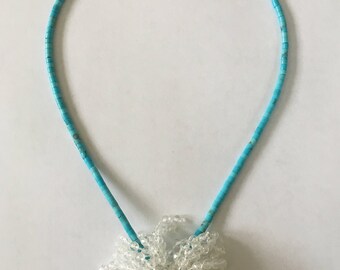 Pouff on turqoise heishi beads