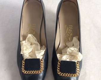 Navy Ferragamo pumps with gold embellishments
