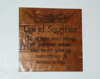 Law of Sacrifice. To attain something of greater value, one must give up something of lesser value. - Plaque 14072
