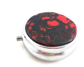 Pill storage tin small round red and black with texture