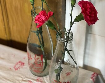 Two vintage advertising milk bottles
