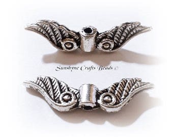 Antique silver-plated "pewter" (zinc-based alloy), 23x6mm double-sided angel wings. Sold per pkg of 20