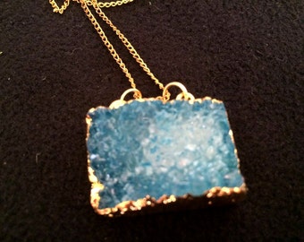 Double hooked blue crystalised stone pendant on gold tone chain