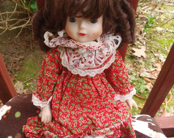Vintage porcelain doll with red dress