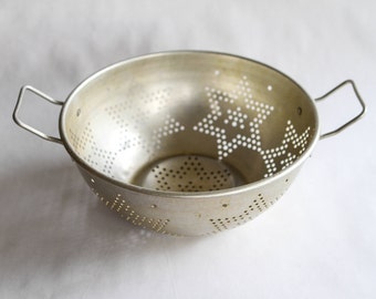 vintage silver metal colander with star pattern
