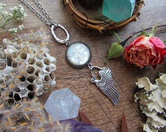 Celestial necklace with carved mother of pearl moon face, angel wing & artisan ring. Sterling silver findings, custom length steel chain.