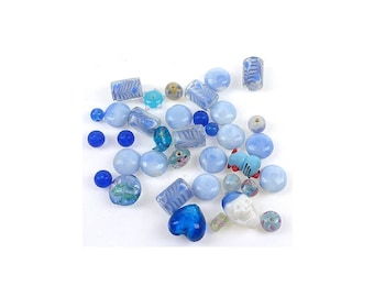 An assortment of blue shaped glass beads variable.