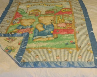 This baby blanket shows the Teddy Bear family at the County Fair. BB9