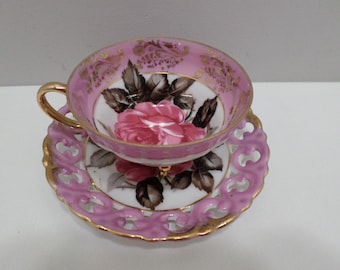 Royal Sealy China tea cup and saucer cup has three gold legs pink with pink rose